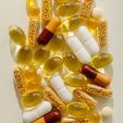 Patch of yellow and white pills in different shapes.